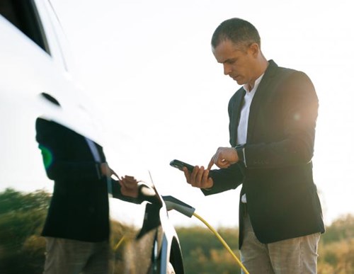 image of a male charging EV outdoors payment app