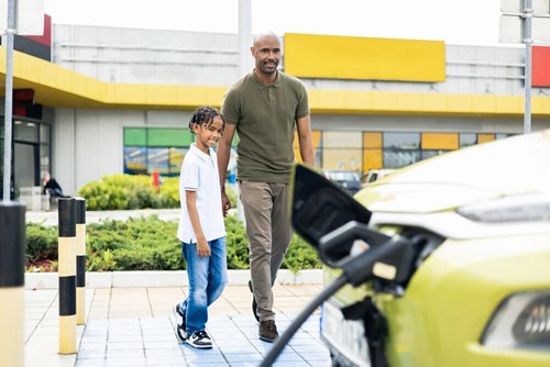 Man and kid walking towards a car