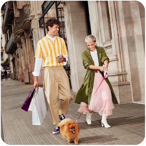 Man and woman walking a dog